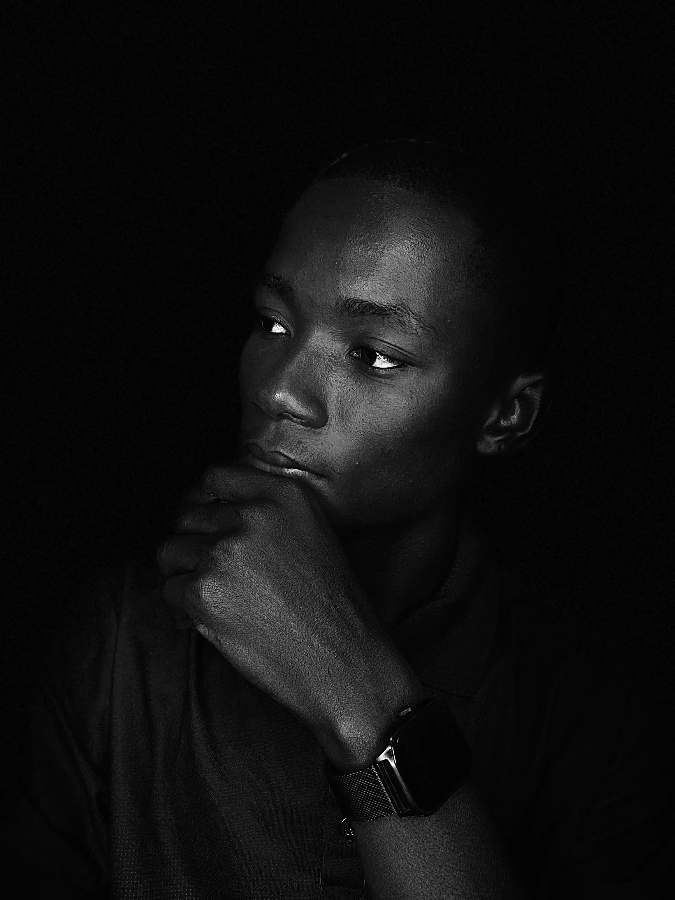 Prince Takyi Akomea, photographed in low key against a dark ground.